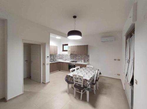 a kitchen with a table and chairs in a room at CASA VACANZE CASANOVA in Agerola