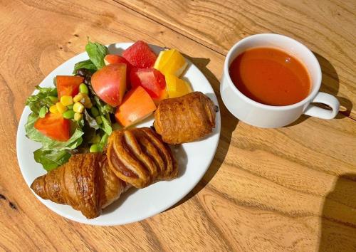 a plate of food with a salad and a cup of tea at EN HOTEL Kyoto in Kyoto