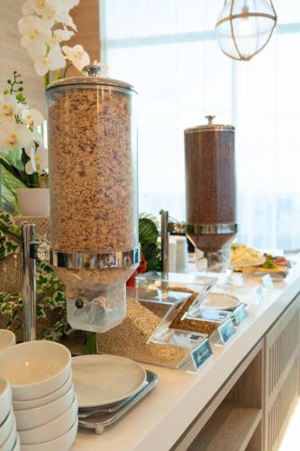 a counter with two large containers filled with food at Aquamare Hotel in San Andrés