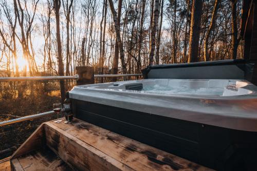 a hot tub sitting on top of a wooden deck at Sherwood Castle by Liv Retreats in Nottingham