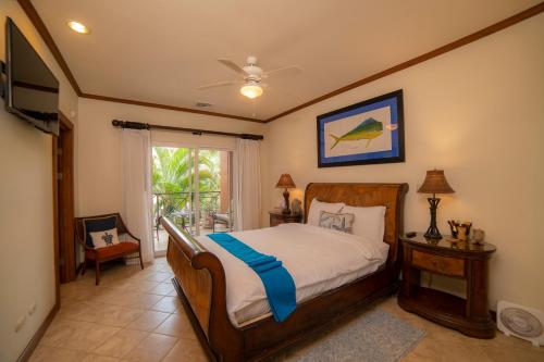 a bedroom with a bed and a television in it at Los Suenos Resort Veranda 6C by Stay in CR in Herradura