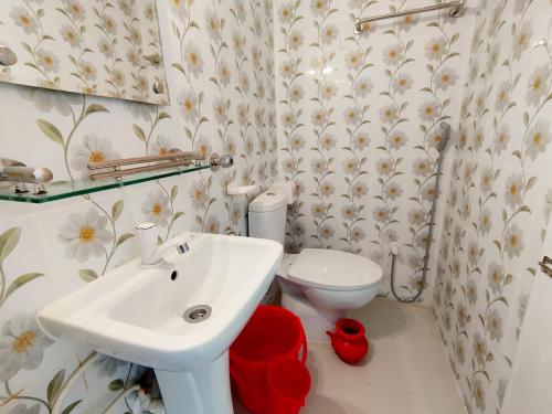 a bathroom with a sink and a toilet at Hotel Labbaik Dhanmondi in Dhaka