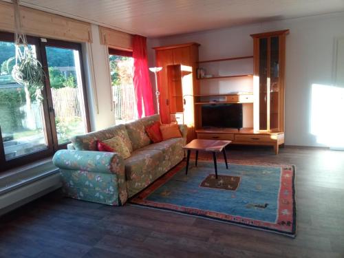 a living room with a couch and a table at Haus am Römerstich in Auen