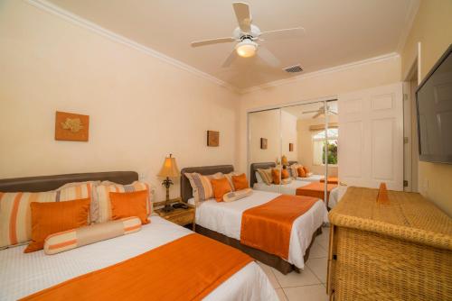 a bedroom with two beds and a ceiling fan at Los Suenos Resort Colina 9E in Herradura