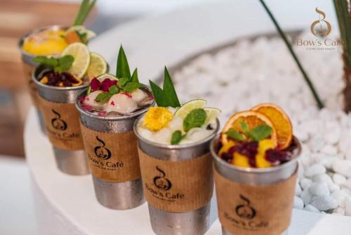 a row of cups filled with different types of desserts at Lavender Tan Thanh Hotel mini resort in Cong Thanh (3)