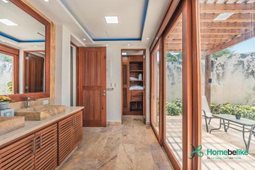 a bathroom with a double sink and a patio at Full of life! Green Village w private pool 28A in Punta Cana