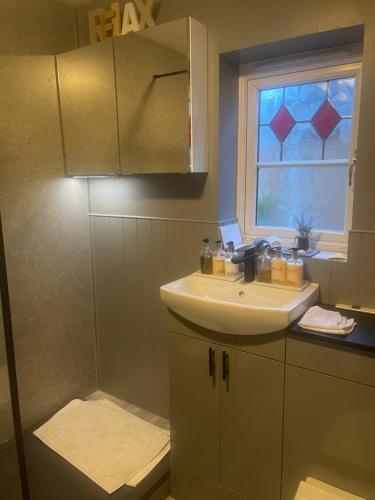 a bathroom with a sink and a window at Morgraig in Cardiff