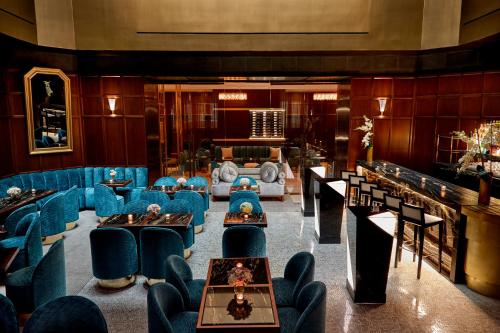 a room with blue chairs and tables in a building at Hotel Belleclaire Central Park in New York