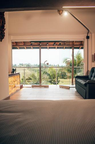 a living room with a couch and a large window at Örök Hotel in Rionegro
