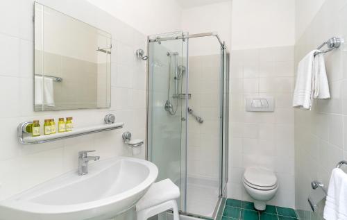 a bathroom with a sink and a shower at Hotel Le Axidie in Vico Equense