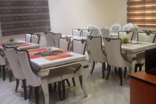 a group of tables and chairs in a room at Alim Royal Hotel in Jahi