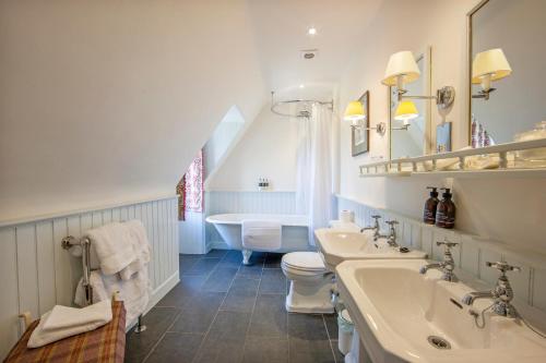 a bathroom with two sinks and a toilet at Barcaldine Castle in Oban