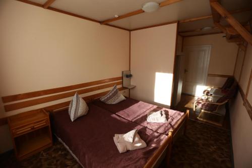 a bedroom with a bed with two pillows on it at Guest House Podobovets 2000 in Podobovets