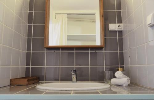 a bathroom with a sink and a mirror at la Ferme de Vazerat in Massiac