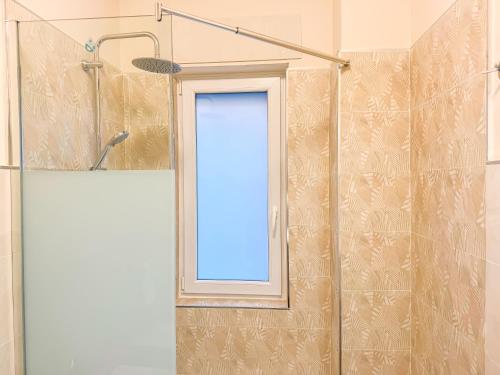 a glass shower door with a window in a bathroom at Brain Harmony Pagani in Pagani
