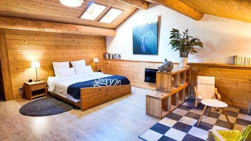 a bedroom with a bed and a tv in it at Le Grenier 1821 - Mini chalet - Centre village - AravisTour in Saint-Jean-de-Sixt