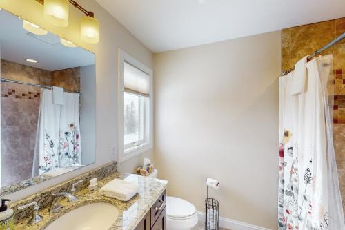 a bathroom with a sink and a toilet and a mirror at 61 East Field Road in Jackson
