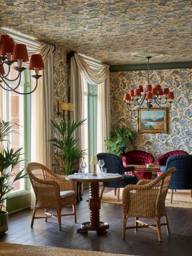 a room with chairs and a table in a room at Marine Troon in Troon