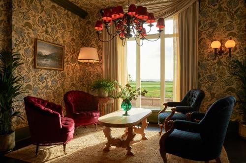 a living room with chairs and a table and a window at Marine Troon in Troon