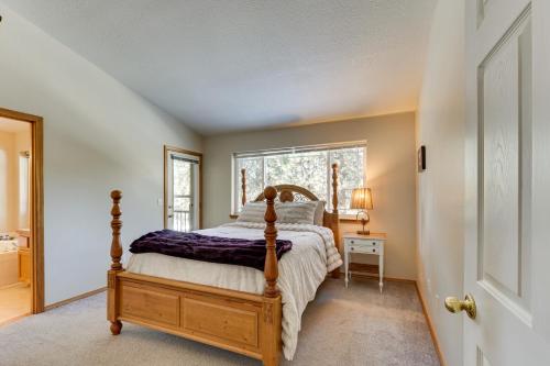 a bedroom with a bed and a window at Klamath Falls Townhome with Deck and Resort Amenities! in Klamath Falls