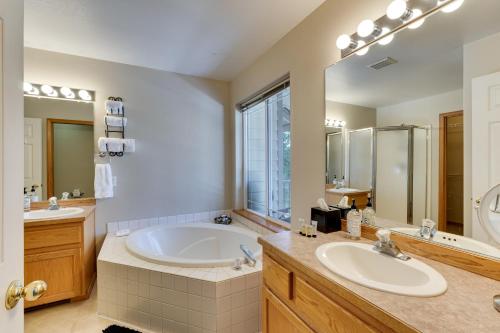 a bathroom with a large tub and a large mirror at Klamath Falls Townhome with Deck and Resort Amenities! in Klamath Falls