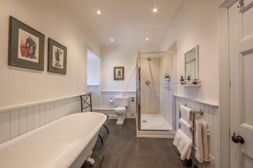 a bathroom with a bath tub and a toilet at Barcaldine Castle in Oban