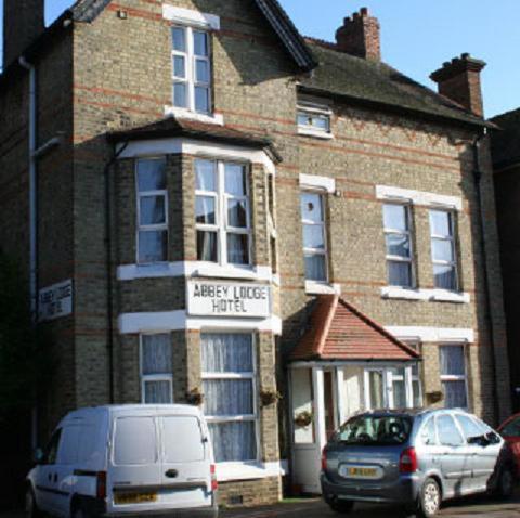 a white van parked in front of a brick building at Abbey Lodge Hotel in London