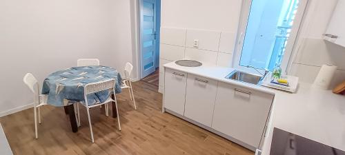 a small white kitchen with a table and a sink at Apartment 3 in Altstadt in Angermünde in Angermünde