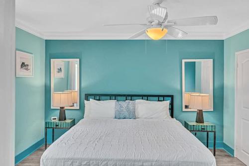 a bedroom with blue walls and a bed with two lamps at Panoramic beachfront Suite in Hollywood
