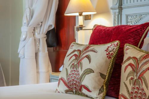 two pillows sitting on a bed next to a lamp at Barcaldine Castle in Oban