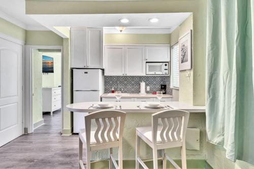 a kitchen with white cabinets and white appliances at Walkabout 3 King Suite on the Ocean in Hollywood Beach in Hollywood