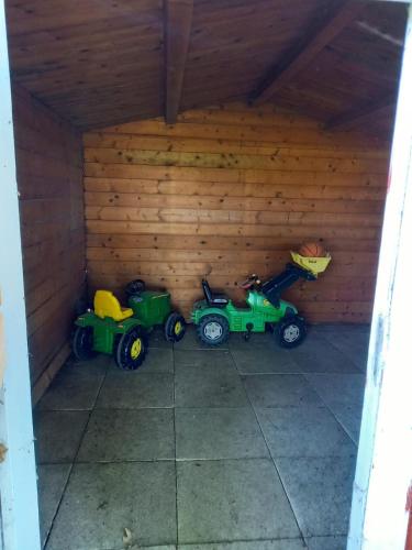 two toy tractors parked in a garage at Ferienhaus Dat Landhuus 95158 in Rhauderfehn