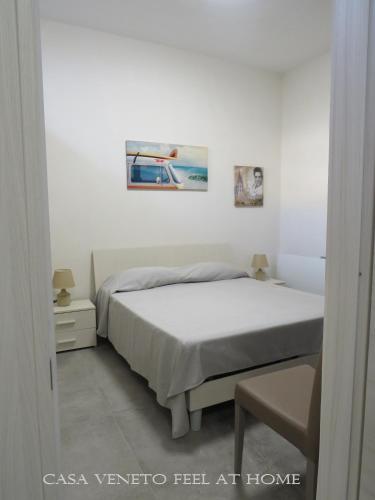 a bedroom with a bed and a picture on the wall at Casa Veneto in Mazara del Vallo