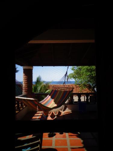 a hammock is hanging from a porch at Big Surf House in Popoyo