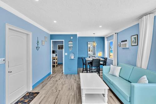 a living room with blue walls and a blue couch at Walkabout 8 Tower Suite with Panoramic Ocean Views in Hollywood