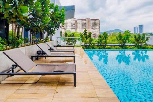 - une rangée de chaises longues à côté de la piscine dans l'établissement NEU Suites Cozy Minimalist#KLCC#2BR#Relax#Netflix, à Kuala Lumpur