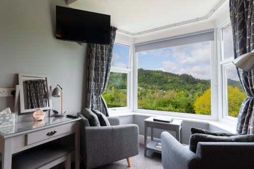 a living room with a large window with a view at Aberconwy House B&B in Betws-y-coed
