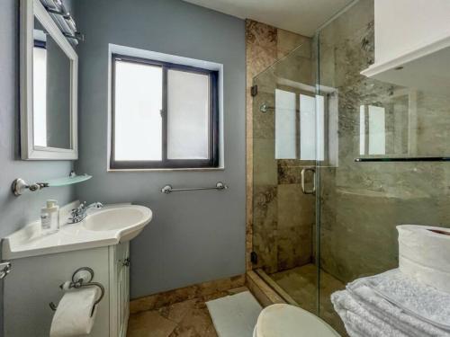 a bathroom with a sink and a glass shower at 111 6 Beautiful waterfront apartment near the beach in Fort Lauderdale