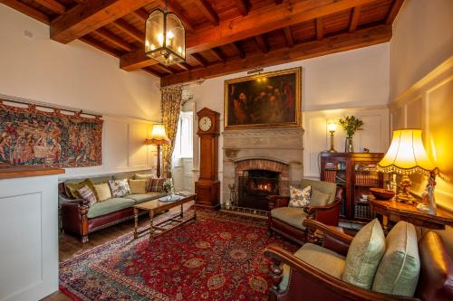 a living room with a fireplace and a couch at Barcaldine Castle in Oban