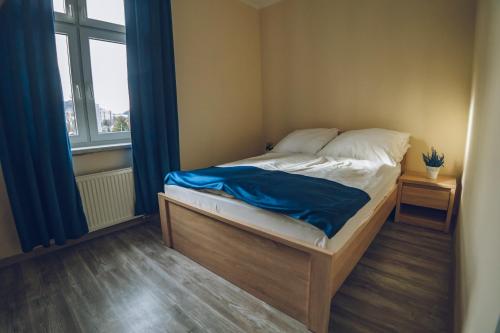 a small bed in a room with a window at Apartamenty ABRACADABRA in Ustroń
