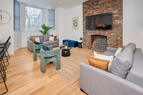a living room with a couch and a fireplace at Host & Stay - Princes Place Hideaway in Liverpool
