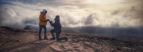 two people standing on top of a mountain looking at the sky at James' Place at The Taff in Merthyr Tydfil