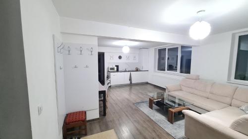 a living room with a couch and a table at Apartament In Inima Dornei in Vatra Dornei