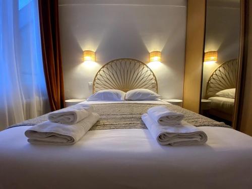 a bedroom with a bed with towels on it at My Pommery#reims in Reims