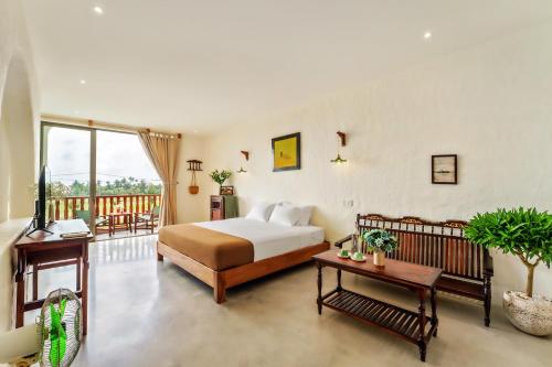 a bedroom with a bed and a balcony at Molila Villa Hoi An by Class6 in An Bang