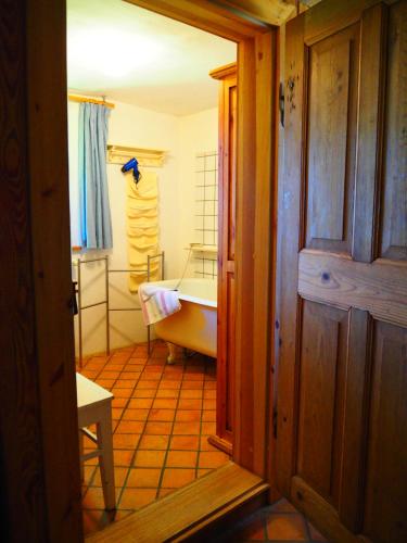 a bathroom with a bath tub and a sink at Eulenhof Vorpommern in Rossin