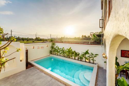 a swimming pool on the balcony of a house at Molila Villa Hoi An by Class6 in An Bang