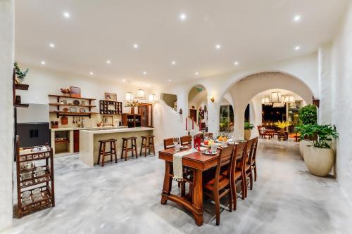a kitchen and living room with a table and chairs at Molila Villa Hoi An by Class6 in An Bang
