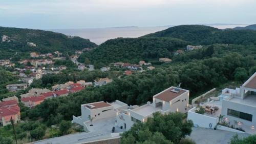 an aerial view of a town with trees and buildings at Merelia Exclusive Villas in Parga