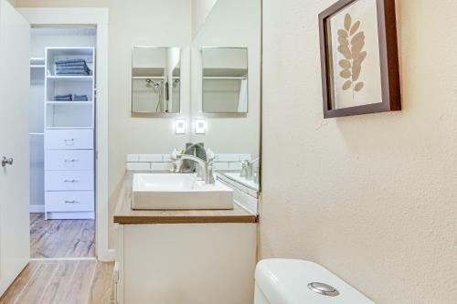 a bathroom with a sink and a mirror at Colorado Springs Condo with Fireplace Near Downtown in Colorado Springs